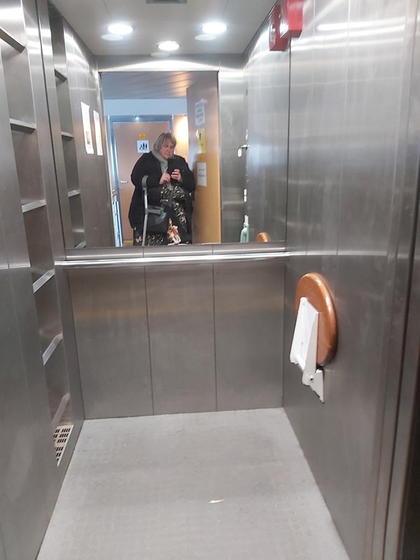 Image of a person standing in an elevator