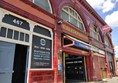 The station frontage, with classic ox-blood coloured glazed tiles.