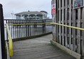 Image of ramp access to the pier. Wooden boards with rails on both sides