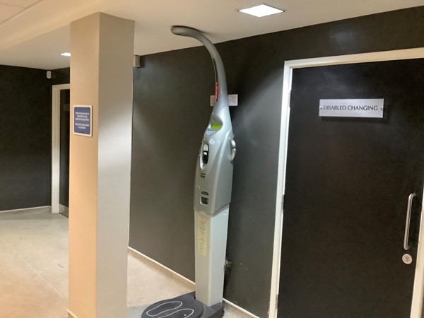 Picture of weighing scales and a door marked "Disabled Changing"