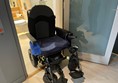 Picture of a powerchair in the bathroom doorway