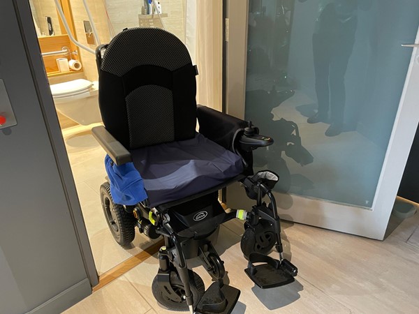 Picture of a powerchair in the bathroom doorway