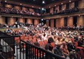 The 2 wheelchair spaces are at the back, above the seating but below the balcony.