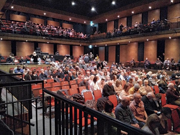 The 2 wheelchair spaces are at the back, above the seating but below the balcony.