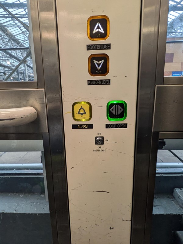 Image of the inside of a lift in the station, there are Braille buttons on the panel.