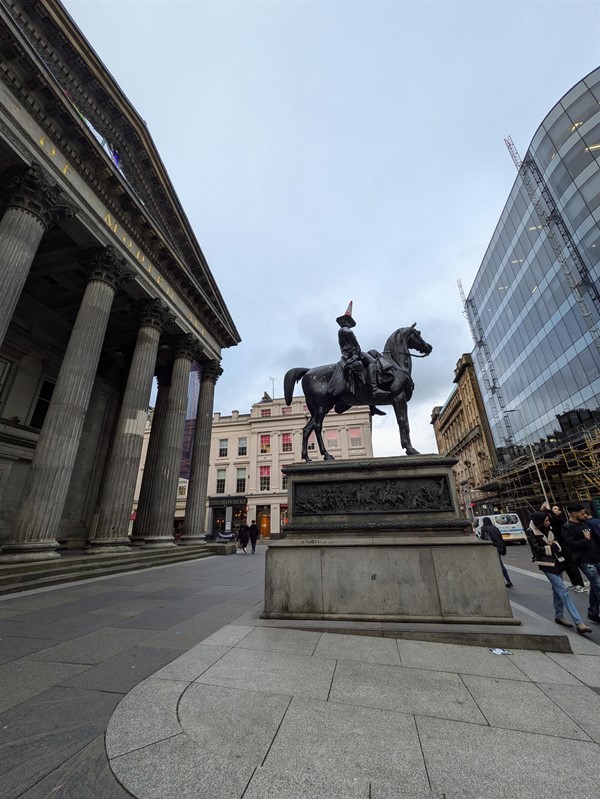 Image of the Duke of Wellington Statue, the statue has a traffic cone on its head.