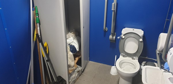 Picture of disabled toilet being used as a store cupboard