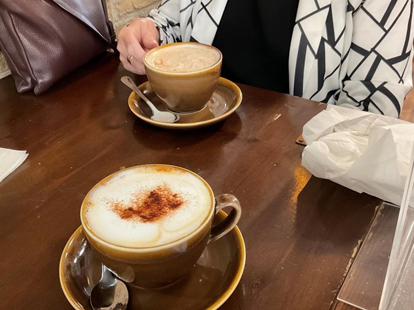 Image of two coffees sitting on a table.