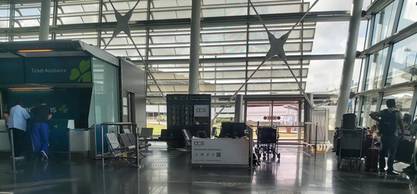 Image of a large glass building with a few chairs