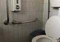 Image of a toilet with grabrails