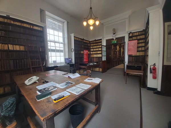 Image of a room with a table and bookshelves