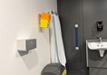 Image of colostomy shelf, sharps bin, hand dryer and adjustable sink with grab rails.