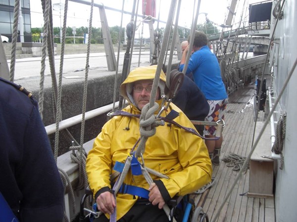 A wheelchair user rigged to go aloft.