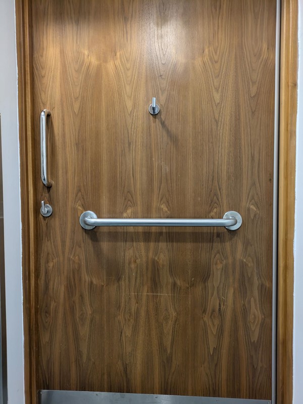 Image of the door from the inside of the accessible toilet