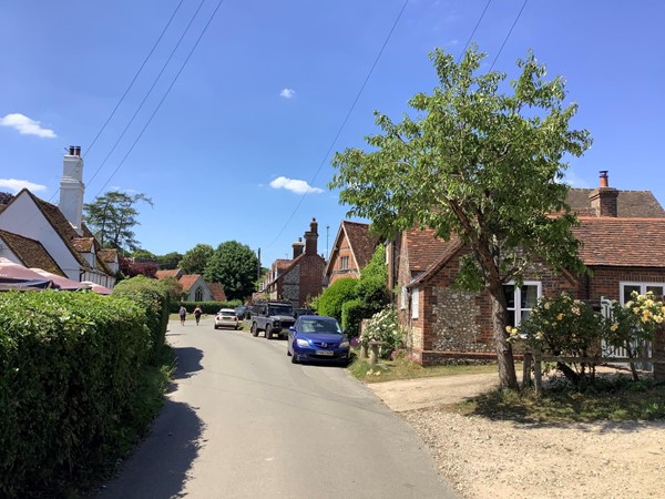 Picture of a road with red brick housing