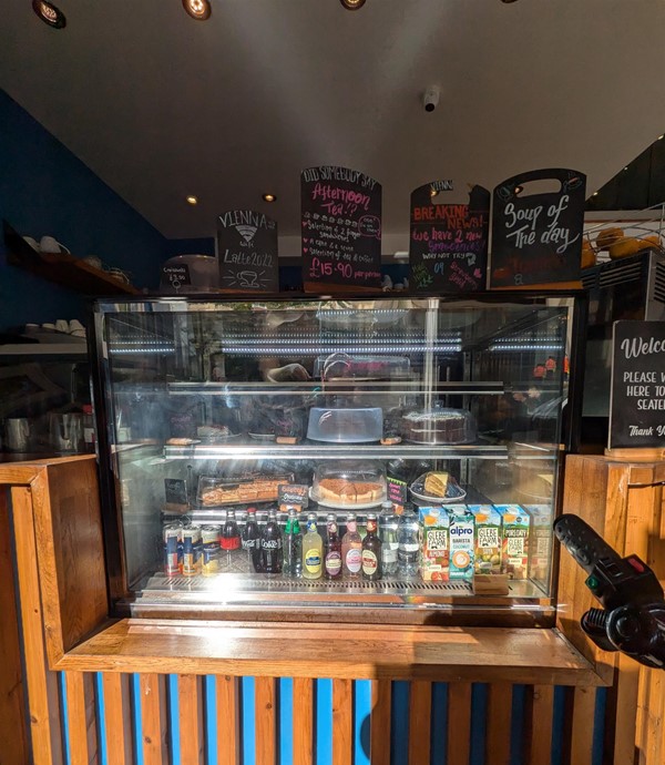 Image of cake cabinet with soft drinks