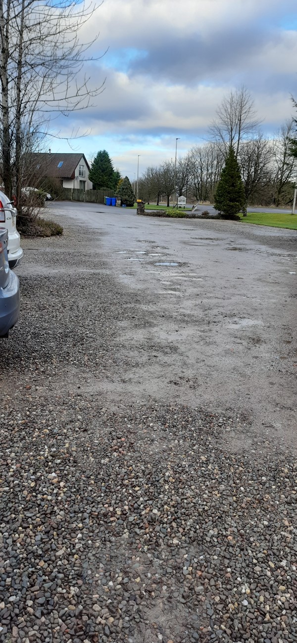 Potholes and gravel on the car park