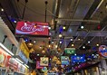 Image of a low ceiling filled with neon signs advertising products