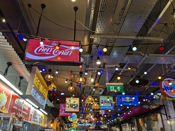 Image of a low ceiling filled with neon signs advertising products