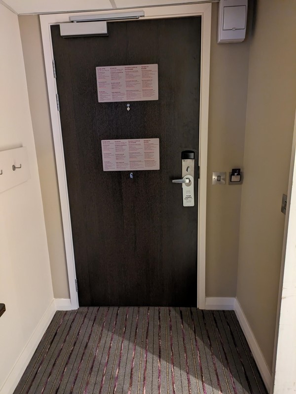 Image of a hotel room door from the interior