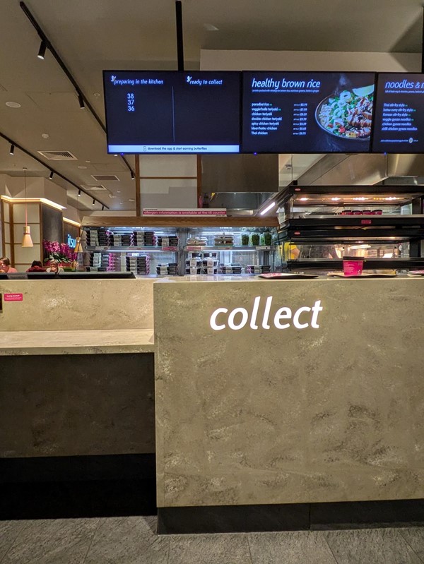 Image of a counter with a sign and a menu