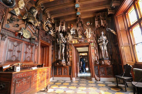 Inside the first room of the house, with smooth floor and wooden door frames, which are fairly wide.