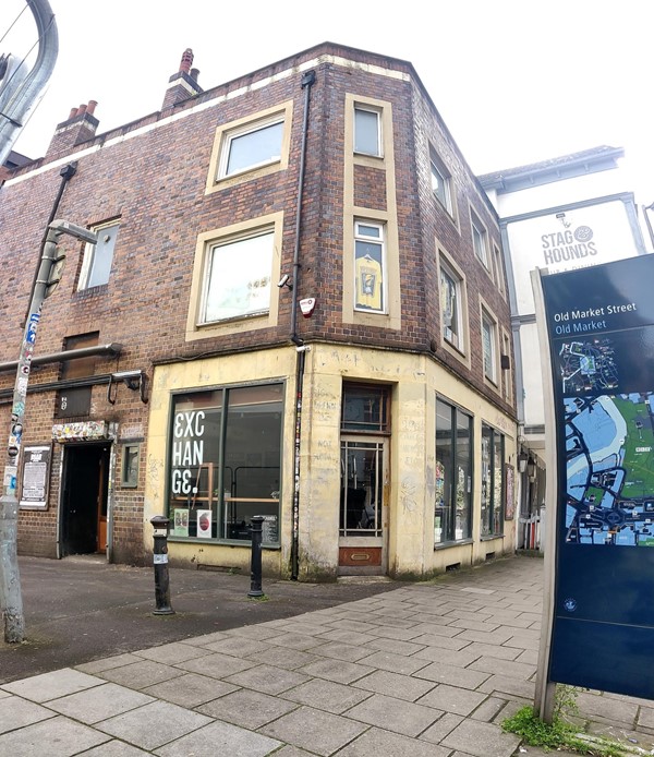 Picture of the front of the exchange from the pavement Infront. Both entrances are visible from the front, the one on the corner of the building is open during the day, and the larger door on the left is open during events. When going to a show, queue up on the left.