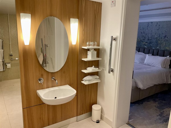 Image of a bathroom with a mirror and a mirror