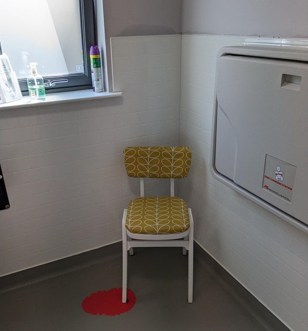 Image of a chair in the accessible toilet.