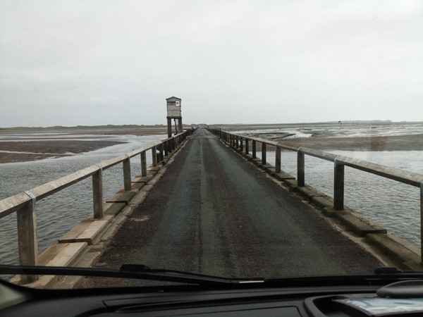 Causeway at low tide that allows vehicles to drive to Holy Island.