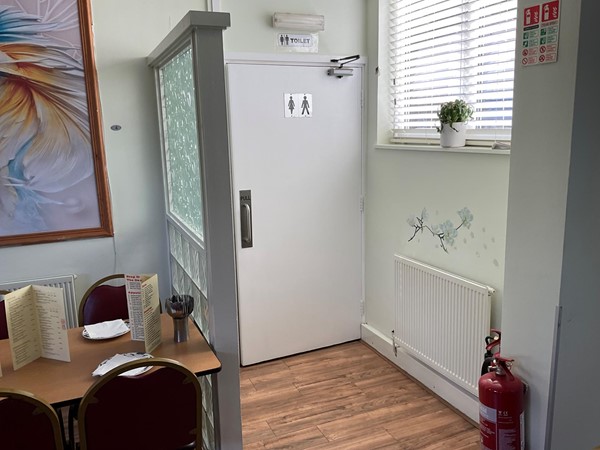 Image of a room with a door and a table