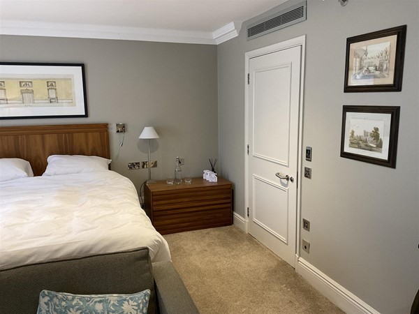 Image of a bedroom with a bed and a bed and a door