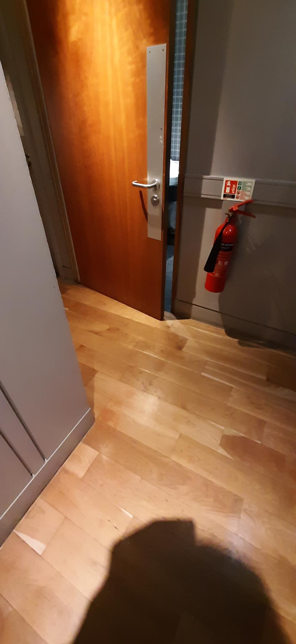 Image of a door with a fire extinguisher