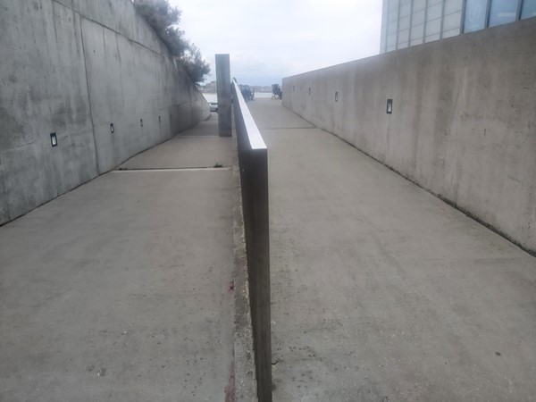 Image of a concrete walkway with a railing