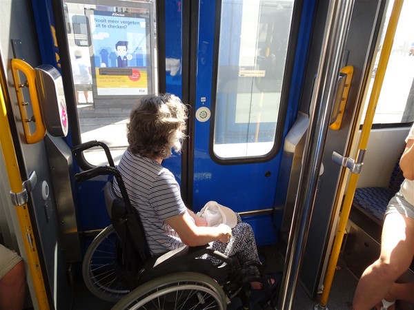 The wheelchair space on one of the older trams. The button to alert the driver that you wish to get off is on the blue door, and one of the pink pads on which you touch your chipkaart is just behind the wheelchair.