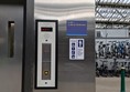 Image of the outside of a lift in the station, there are Braille buttons on the panel.