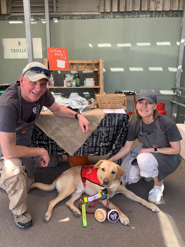 Picture of two people with an assistance dog at Darts Farm