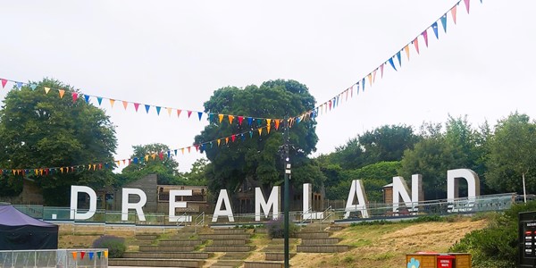 Image of a sign with flags over it