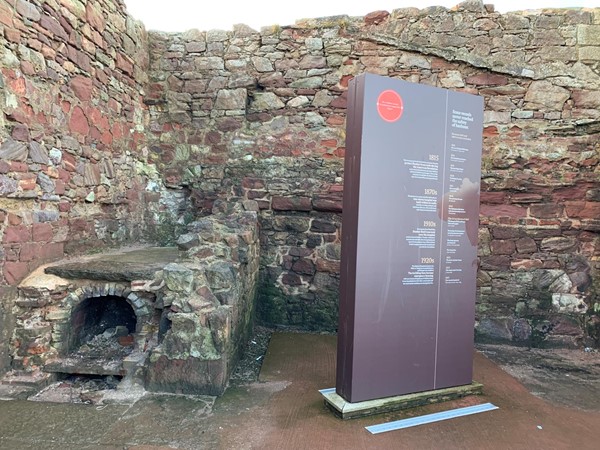 Information stand and stone wall