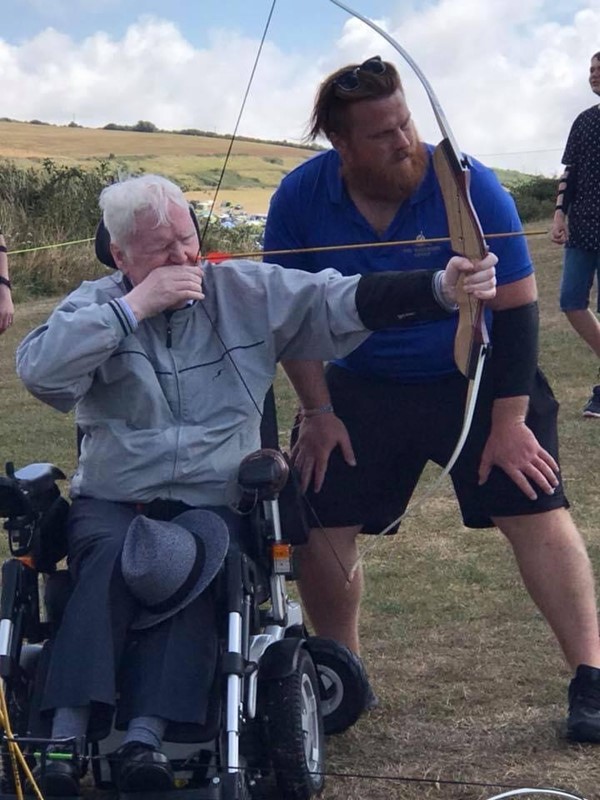 My husband having a go at archery from his wheelchair. This pic is from a couple of years ago as his arms are now too weak. Photo is to show what is still available.