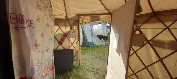 Image of a tent looking out at other tents