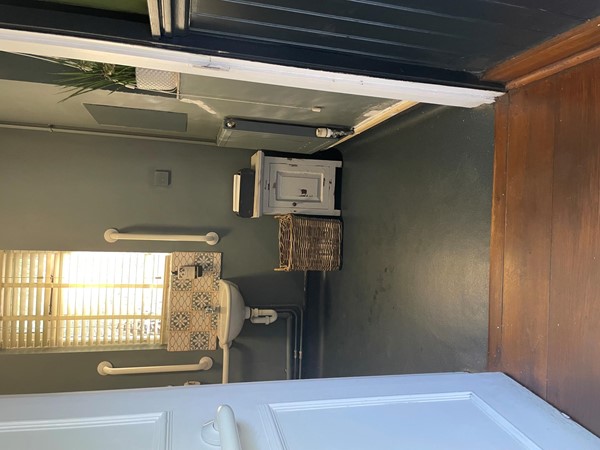 Image of a bathroom with a sink and a basket