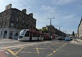An Edinburgh tram passing Macdonald Road junction as it heads down Leith Walk and toward to the docks