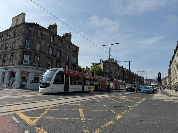 An Edinburgh tram passing Macdonald Road junction as it heads down Leith Walk and toward to the docks