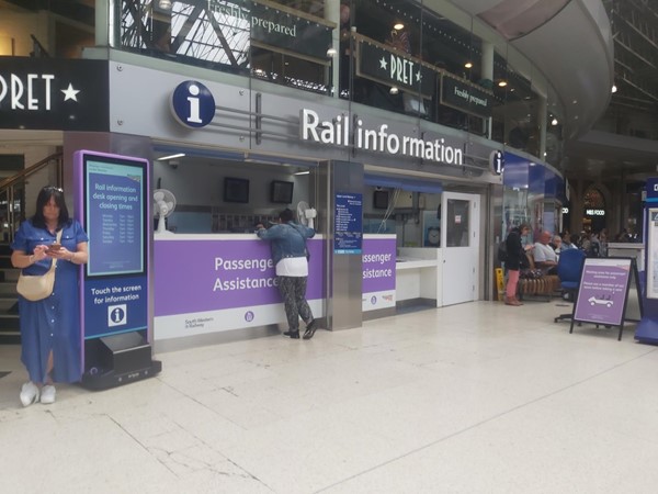 People standing in front of a train station