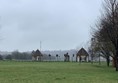 Two small buildings on each side of the main A308, known as “Piers”