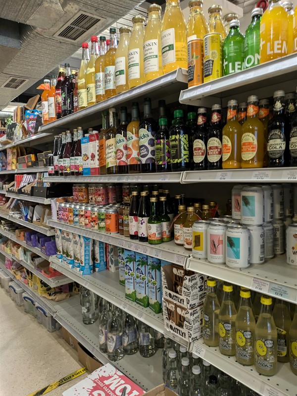 Shelves with a variety of soft drinks and milks