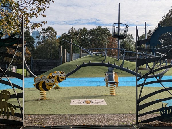 Wide view of the park showing the spring rockers and climbing frame