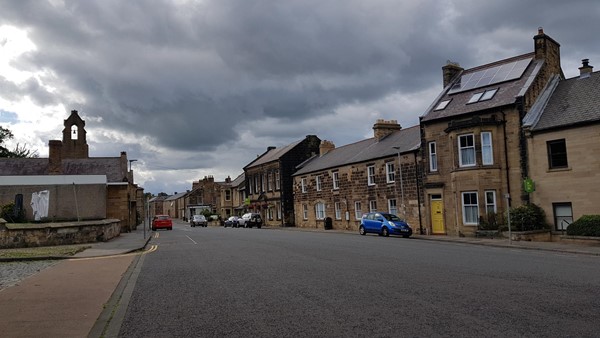 Alnwick Youth Hostel (takes up most of the buildings on the right) with blue badge street parking on the left