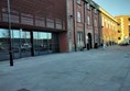 The main entrance is now towards the right of the glass windows, behind which is the bar and auditorium.